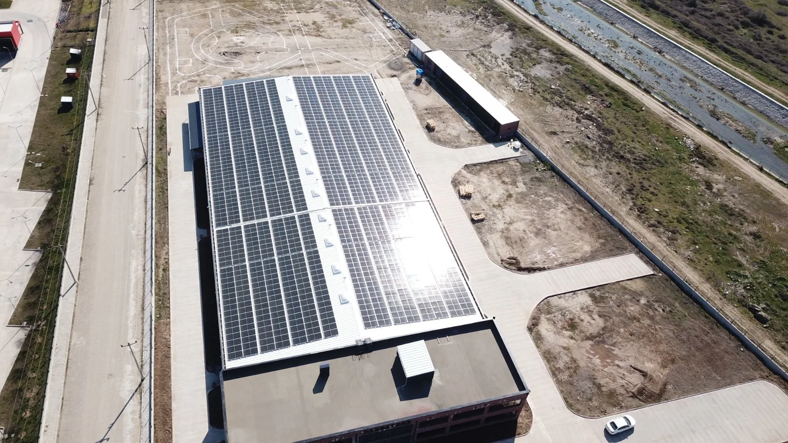 Angled drone view of the long solar-panelled roof of the Erbaa factory
