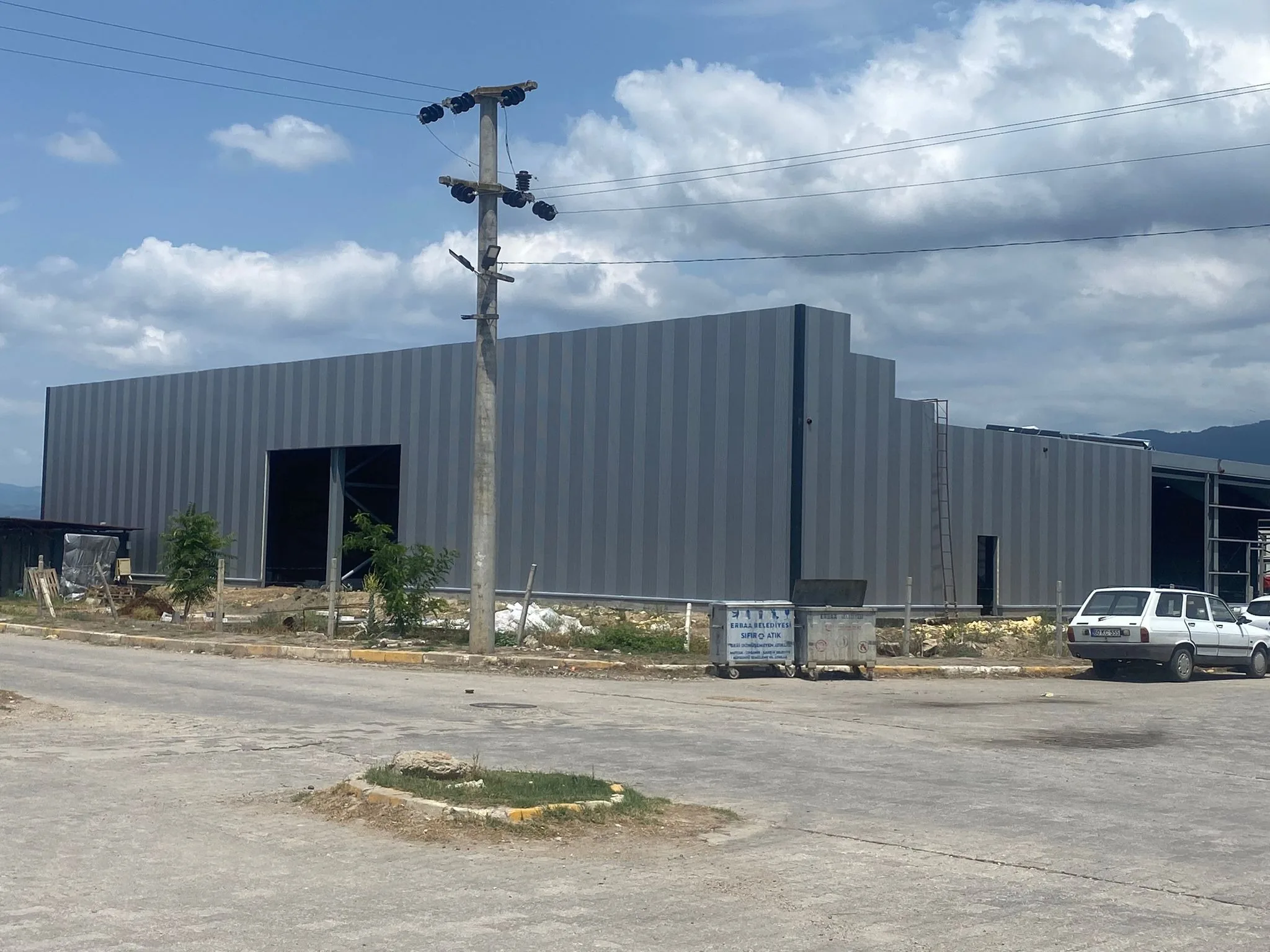 The second Darsateks factory under construction in July 2024, its steel frame clad in grey panels