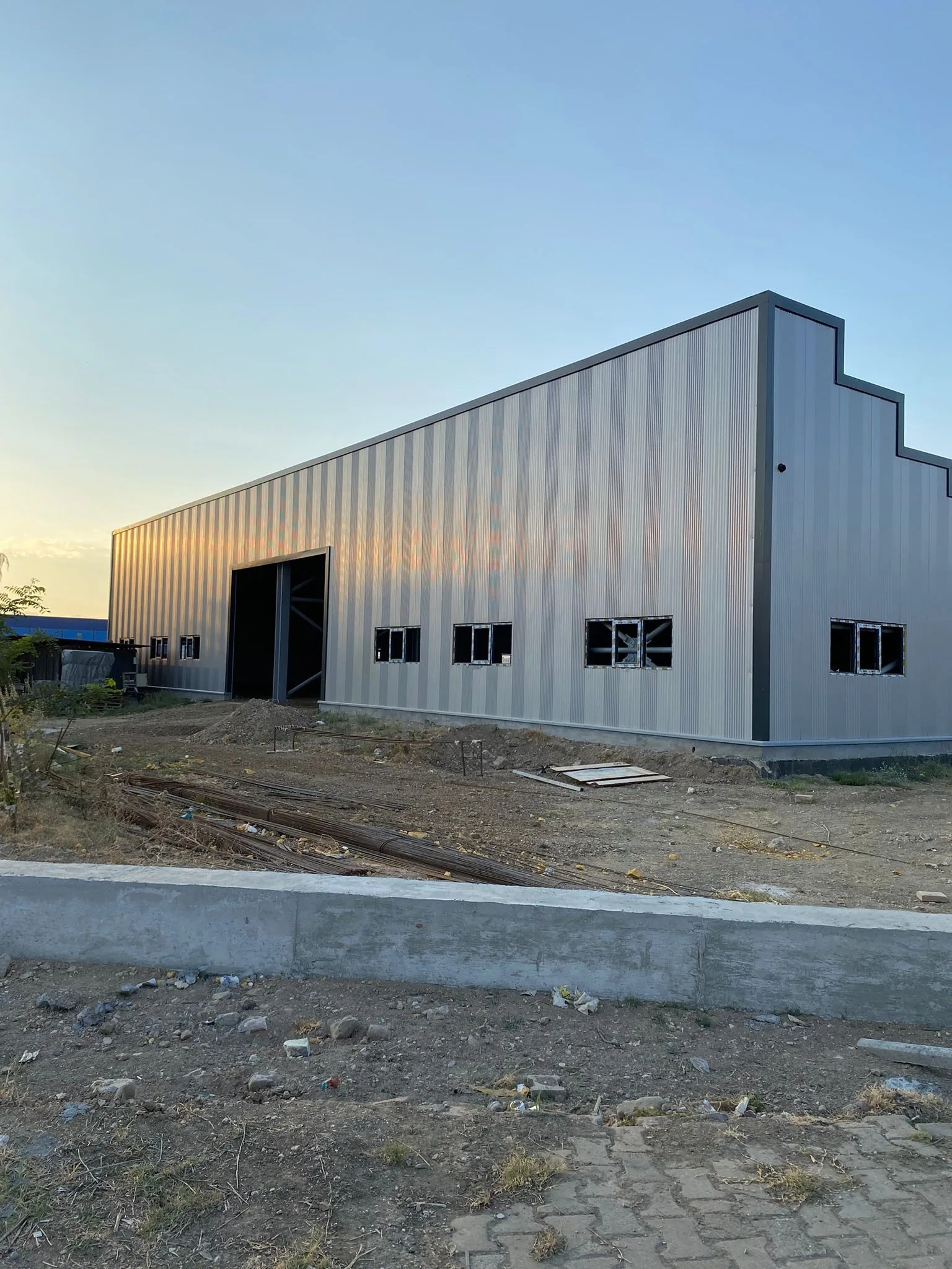 The steel-clad shell of the second Darsateks factory in Erbaa in evening light, August 2024