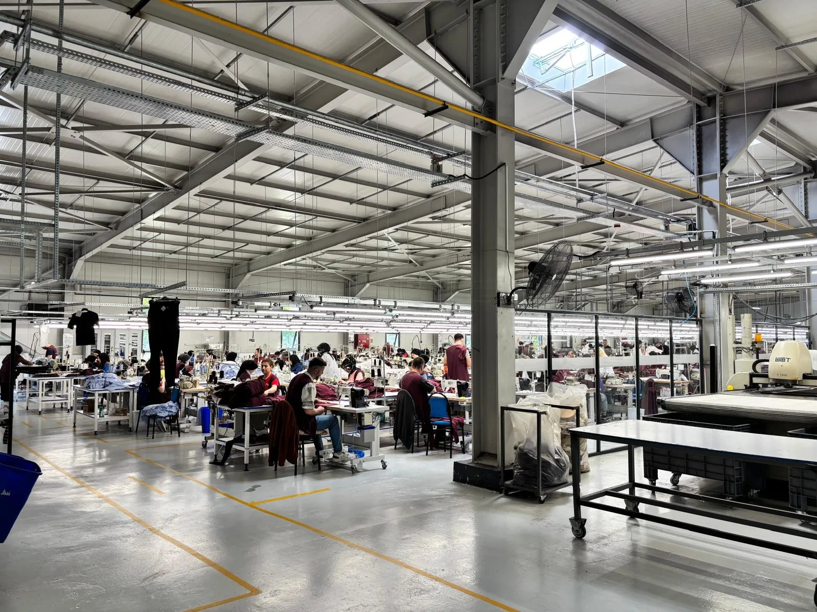 The Erbaa production hall under a steel roof with skylights and long LED strip lights