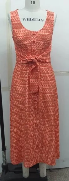 Sample of an orange printed sleeveless dress with a button front and tie waist on a fitting mannequin, made for Whistles